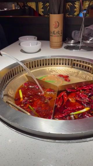 A hot pot with seafood on a table in a restaurant